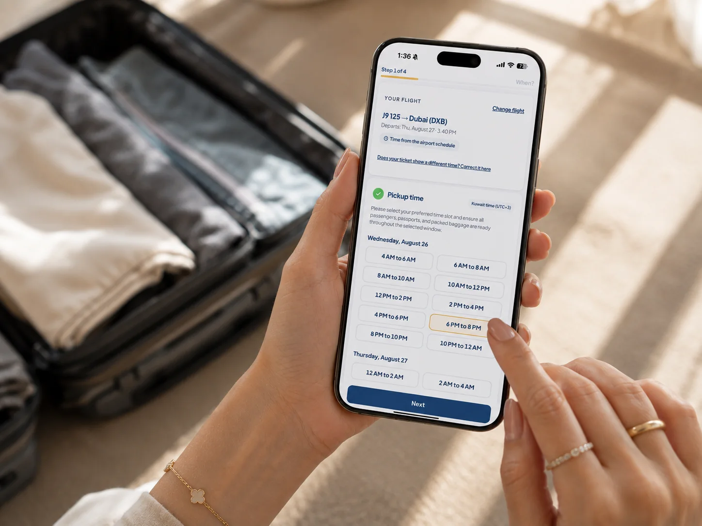 A passenger choosing a pickup time slot on the FlyThru booking screen while packing a suitcase