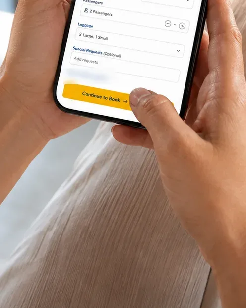 A passenger booking their FlyThru home check-in on a phone, with a FlyThru documents wallet on the table